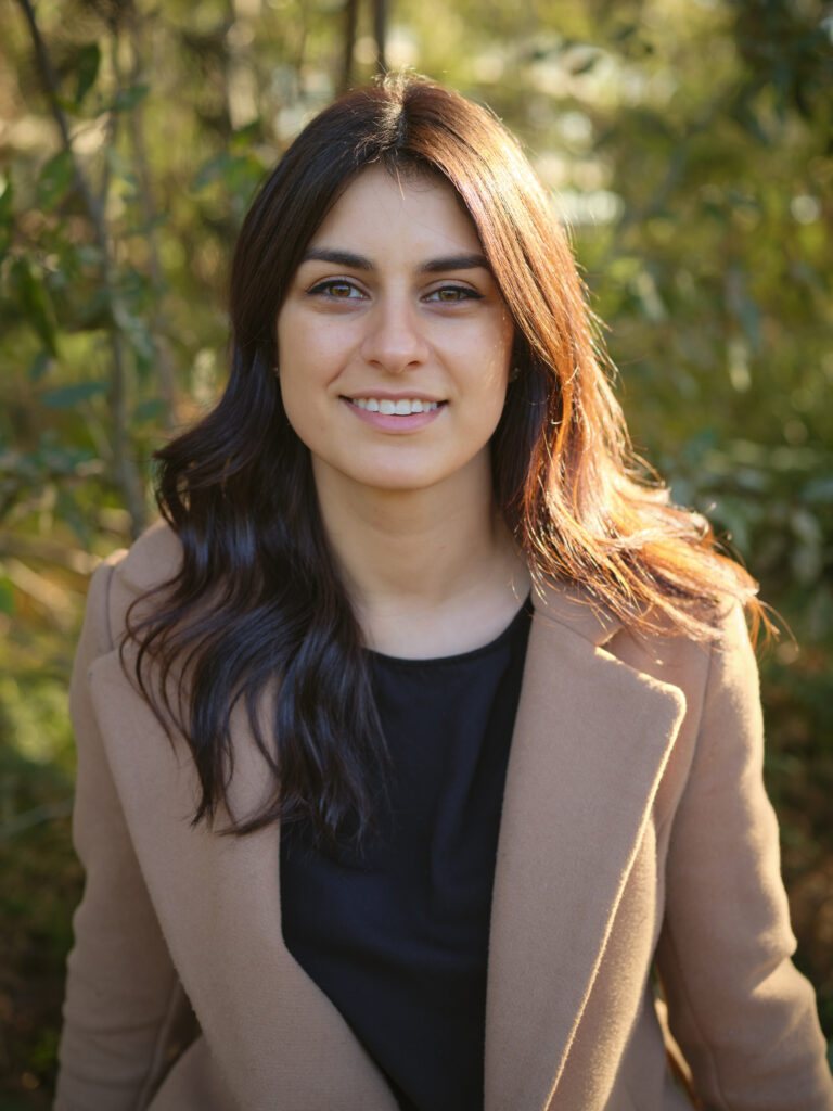 Portrait of a smiling female psychologist in a natural outdoor setting. Greek psychologist in Melbourne Christian psychologist Melbourne Adolescent psychologist Caulfield North Grief counselling psychologist Telehealth psychologist Melbourne DBT psychologist Melbourne Trauma psychologist Melbourne Mental health support for young adults Caulfield North psychologist Oakleigh psychologist